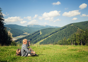 Fototapeta na wymiar Young traveler enjoying mountain view