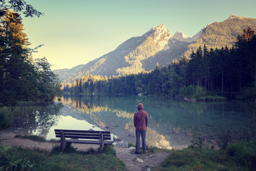Man standing near the mountain lake