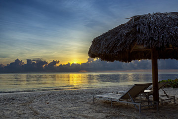 Sunbeds on the beach at sunrise