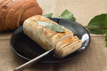 lard with laurel leaf on a plate