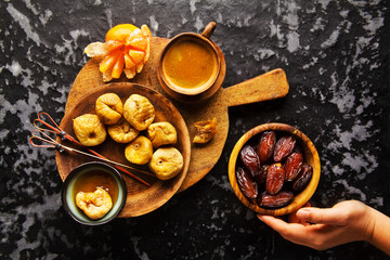 dried fruit: Figs and Dates on a wooden board, on a dark backgro