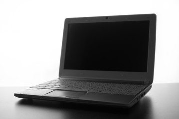 Compact white laptop silhouette on white background.