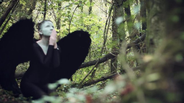4k Halloween Dark Angel Woman with Black Wings in Forest Praying