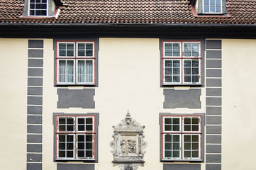 Old house wall with red windows in Riga