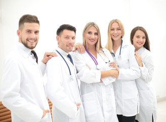 Team of medical professionals  looking at camera, smiling.