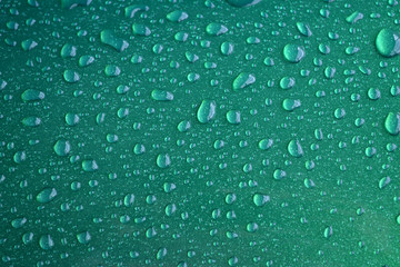 Glittery Green Droplets/Close up of rain drops on shiny metal background