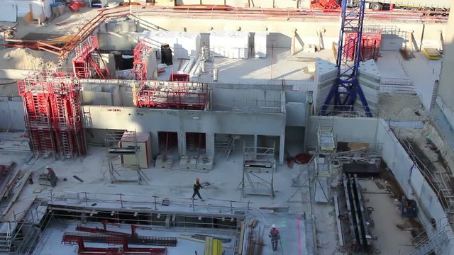 Workers hard at work on a large scale construction site filmed in Paris. Time lapse shot for stylized shot