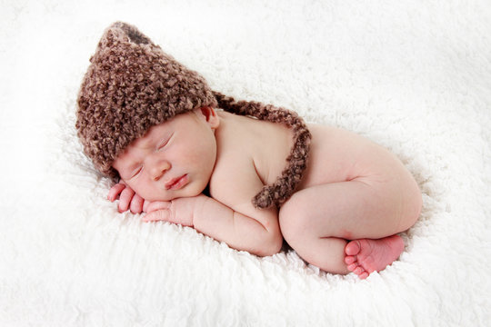 Newborn baby boy asleep on a blanket. 