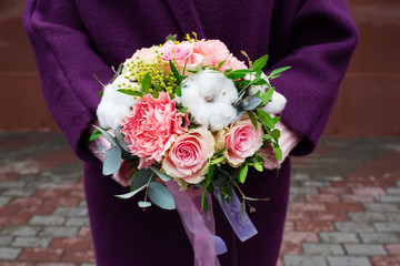 Beautiful bouquet of flowers with cotton in female hands