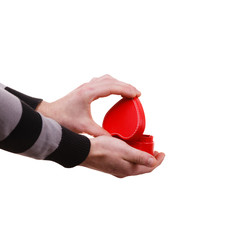 Man holds heart shaped gift box in hand