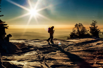  skier reaching the summit at sunset