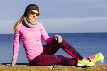 Woman resting after doing sports outdoors on cold day