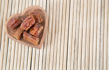 Slices of dehydrated banana on the wooden background