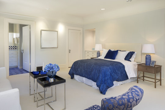 Amazing bedroom with blue decoration in luxury home with copy space. - Powered by Adobe