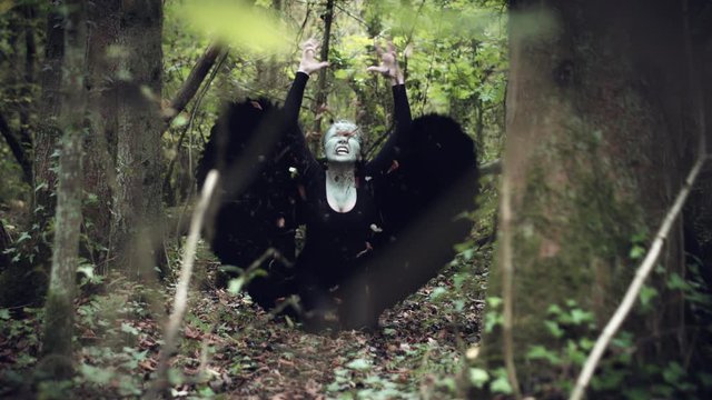 4k Halloween Dark Angel Woman with Black Wings Hitting Ground, slow-motion