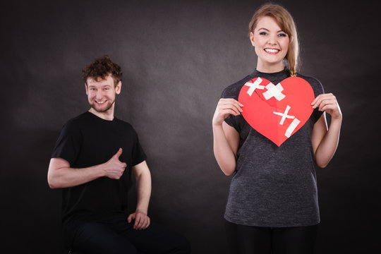 Couple holds broken heart joined in one
