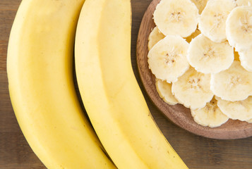 Slices banana on wooden background