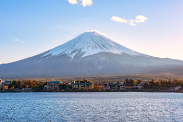 Japan, Fuji mountain, Kawaguchiko lake in autumn afternoon, With warm sunlight effect created reflection highlight shadow at the mountain, land, lake and building.