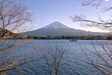 Japan, Fuji mountain, Kawaguchiko lake in autumn afternoon, With warm sunlight effect created reflection highlight shadow at the mountain, land, lake and building.