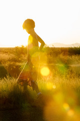 Girl in field at sunset