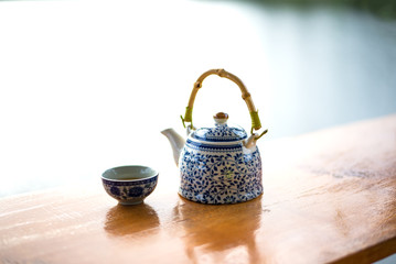 Teapot and cups on table in the sunrise