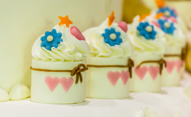 Sweet wedding cupcakes./ Sweet beauty flower and topping pastel color on wedding cake decoration.