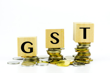 Finance Concept with Stack of Coins - GST (Good and Services Tax) written on