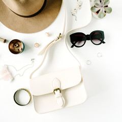 Flat lay trendy creative feminine accessories arrangement. Purse, hat, sunglasses, female accessories. Top view