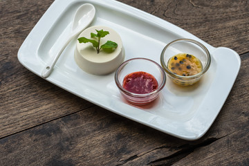 Dessert panna cotta with fresh berries on wooden background, selective focus.Traditional Italian dessert. Valentines Day background