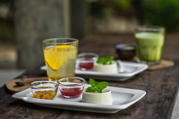 Dessert panna cotta with fresh berries on wooden background, selective focus.Traditional Italian dessert. Valentines Day background