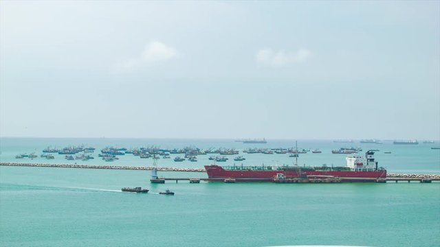 Pacific Ocean Seaport Scene of Lima in Peru with a Large Oil Tanker Ship in Foreground and Many Local Fishing Boats on the Background Sea Horizon