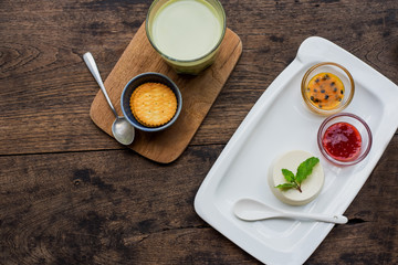 Dessert panna cotta with fresh berries on wooden background, selective focus.Traditional Italian dessert. Valentines Day background