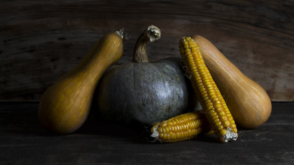 Pumpkin, Corncob and autumn leaves Decoration on a wooden table