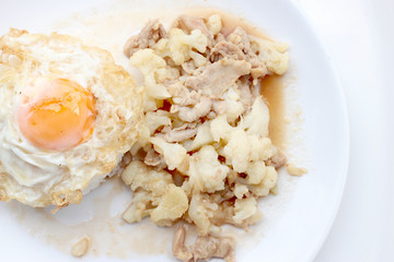 Fried cauliflower with pork, fried eggs with rice in white dish isolate on white background, Thai style food