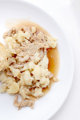 Fried cauliflower with pork, fried eggs with rice in white dish isolate on white background, Thai style food