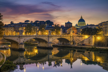 Fototapeta premium St. Peter's cathedral (Basilica di San Pietro) and bridge (Ponte Vittorio Emanuele II) over river Tiber in the evening after sunrise, Rome, Italy, Europe