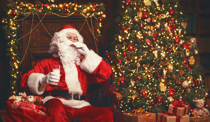 Fototapeta na wymiar Santa Claus eating cookies and drinking milk on Christmas