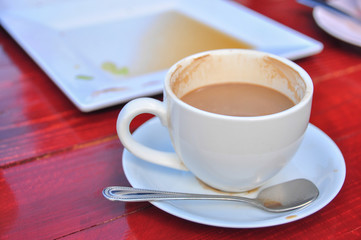Hot coffee in white cup on wooden table
