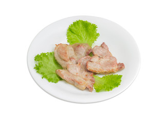 Fried pork on lettuce leaves on white dish