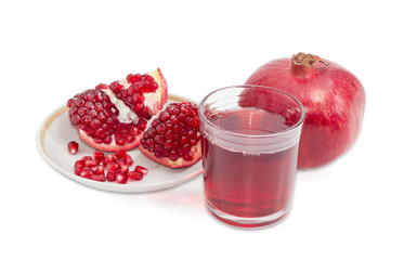 Pomegranate juice in glass, whole pomegranate and peeled pomegranate