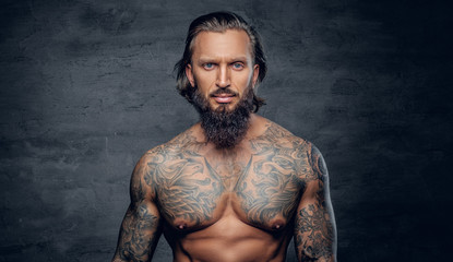 Hipster male with tattooed muscular body.