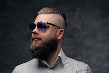 Bearded hipster male in purple sunglasses.