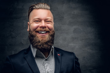 Laughing bearded  male dressed in a purple suit.