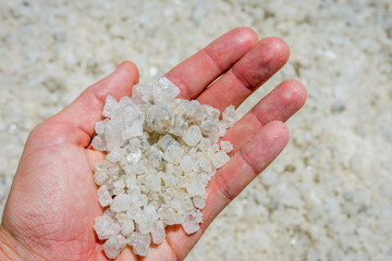 Fototapeta na wymiar Holding salt crystals in hand