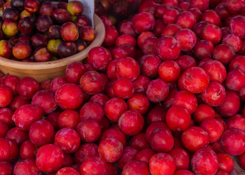 Natural-looking fruits in a supermarket - plums.