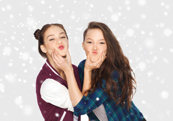 happy smiling teenage girls having fun over snow