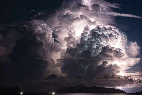 Thunderstorm over island at night