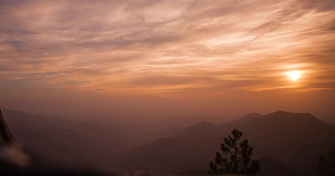 Sequoia National Park, California, USA - view from the granite dome of Moro Rock formation at spectecular sunset with colorful sky and clouds - Timelapse with zoom in 