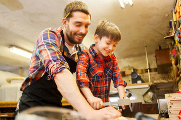 boy and dad with calipers measure wood at workshop