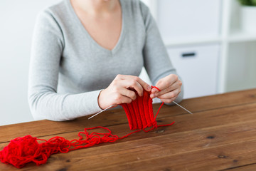 woman hands knitting with needles and yarn